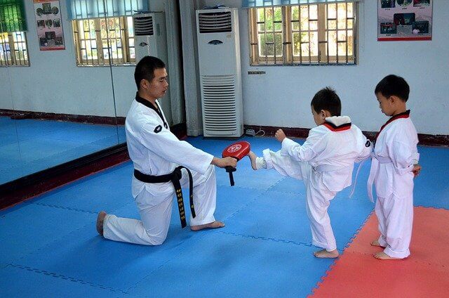 kids training karate with an instructor